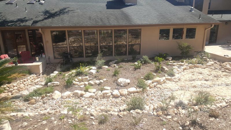 Rock-edged beds along the house